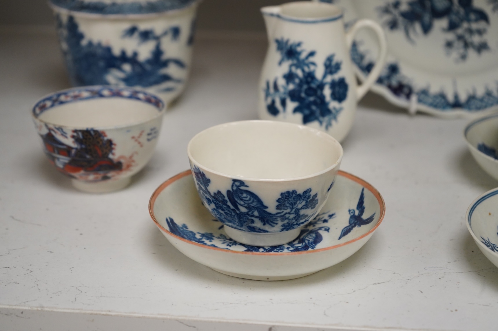 A collection of late 18th century Worcester, Caughley and Liverpool blue and white tea wares to include tea bowls and saucers, jug, suger basin and cover and two dishes etc, largest 23cm in diameter